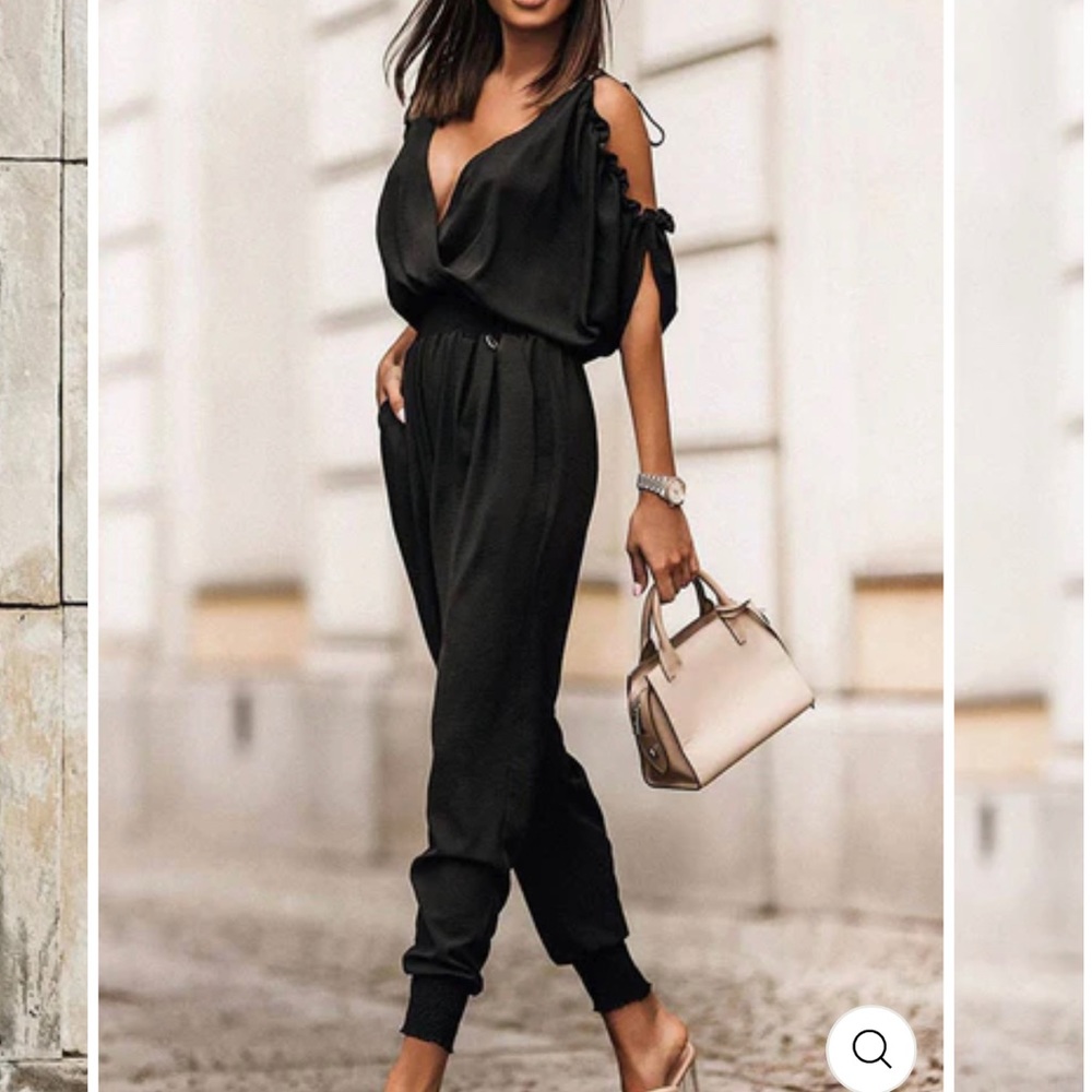 Black jumpsuit with cutout shoulder and straps.